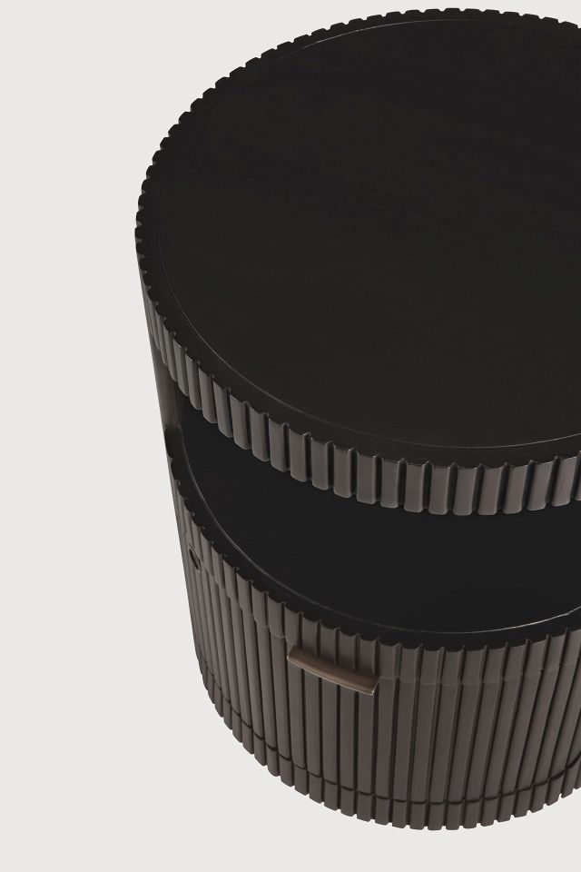 Detailaufnahme: Runder, dunkler Ethnicraft Rollcontainer mit Schublade und geriffelter Oberfläche.