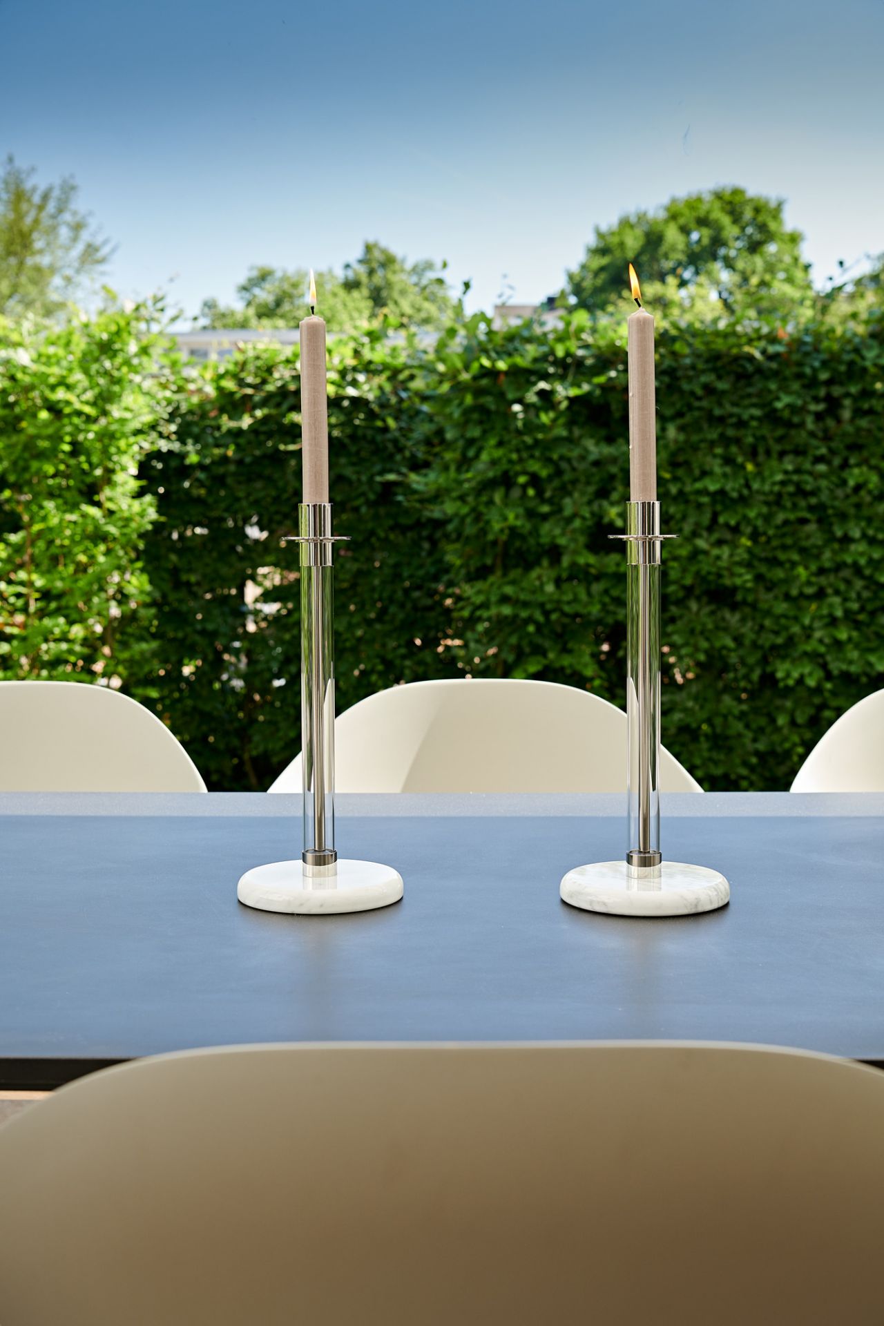 Zwei SL 30 Bauhaus Sabbatleuchter von Tecnolumen aus Onyx mit brennenden Kerzen auf Tisch.