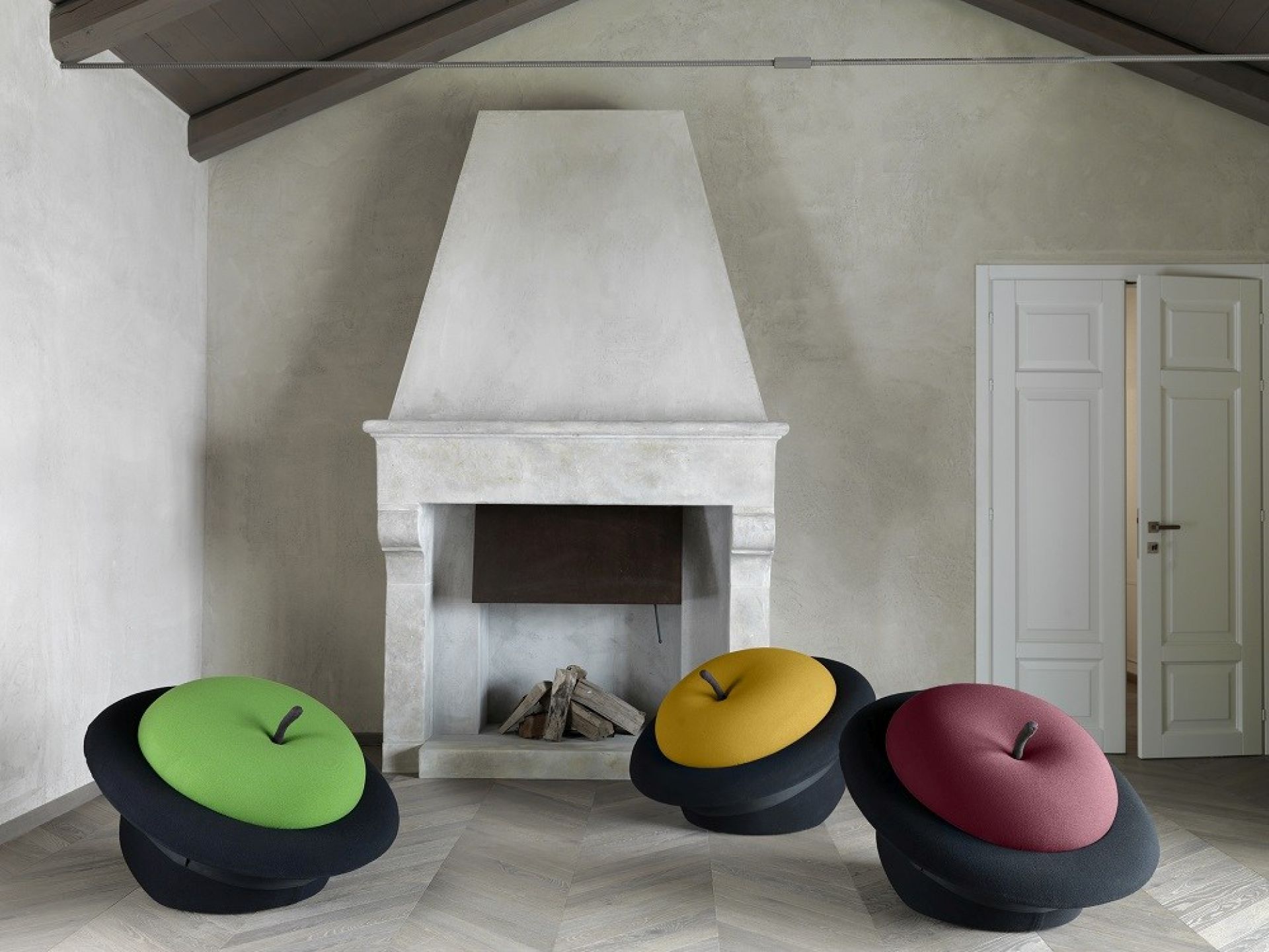 MagriTTA Sessel: Drei farbenfrohe Apfel-Sessel/Poufs von Gufram im Wohnzimmer mit Kamin. Designmöbel für modernes Wohnen.