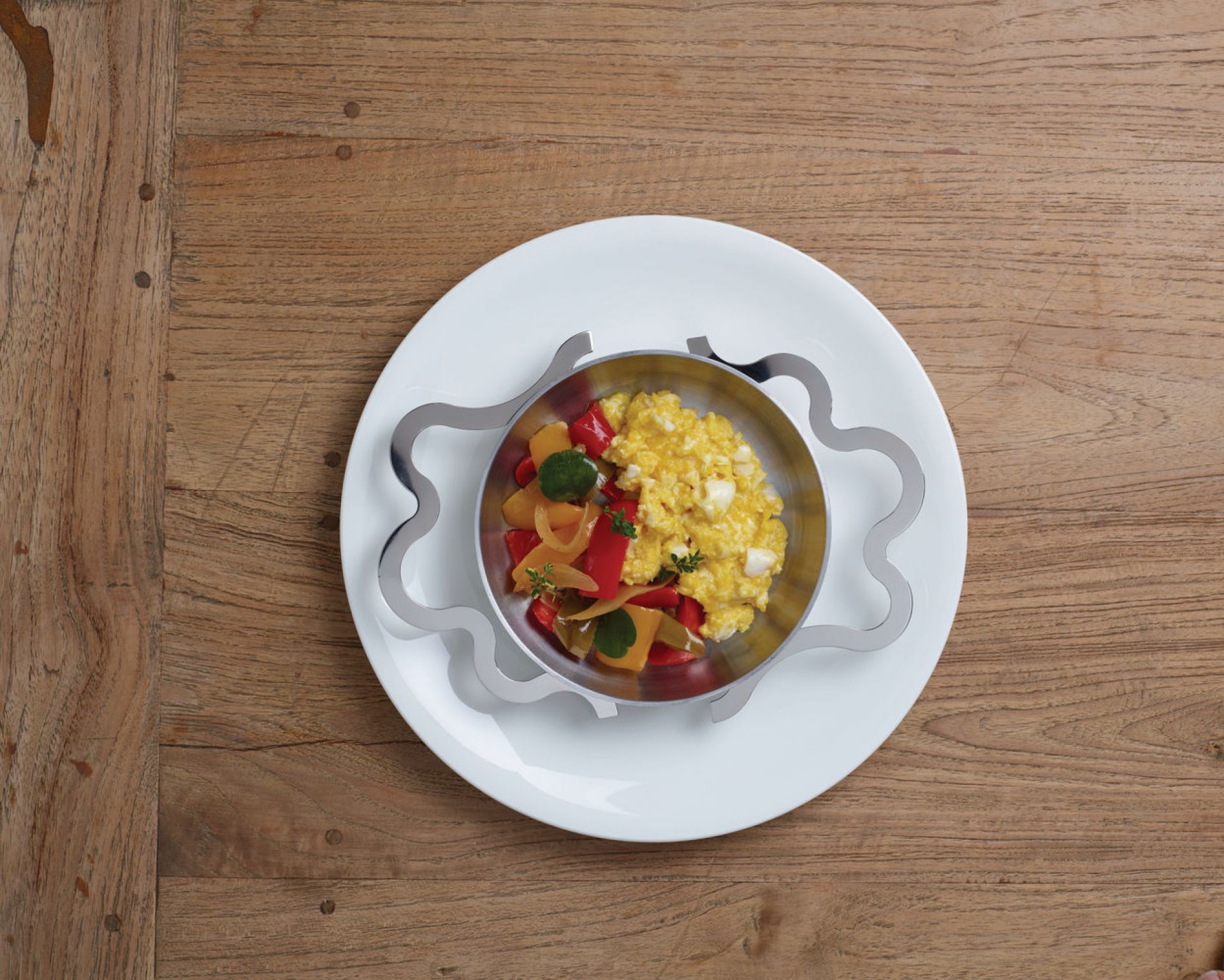 Alessi Tegamino Pfanne mit Speise auf Teller, hochwertige Edelstahl Servierpfanne für stilvolles Anrichten.