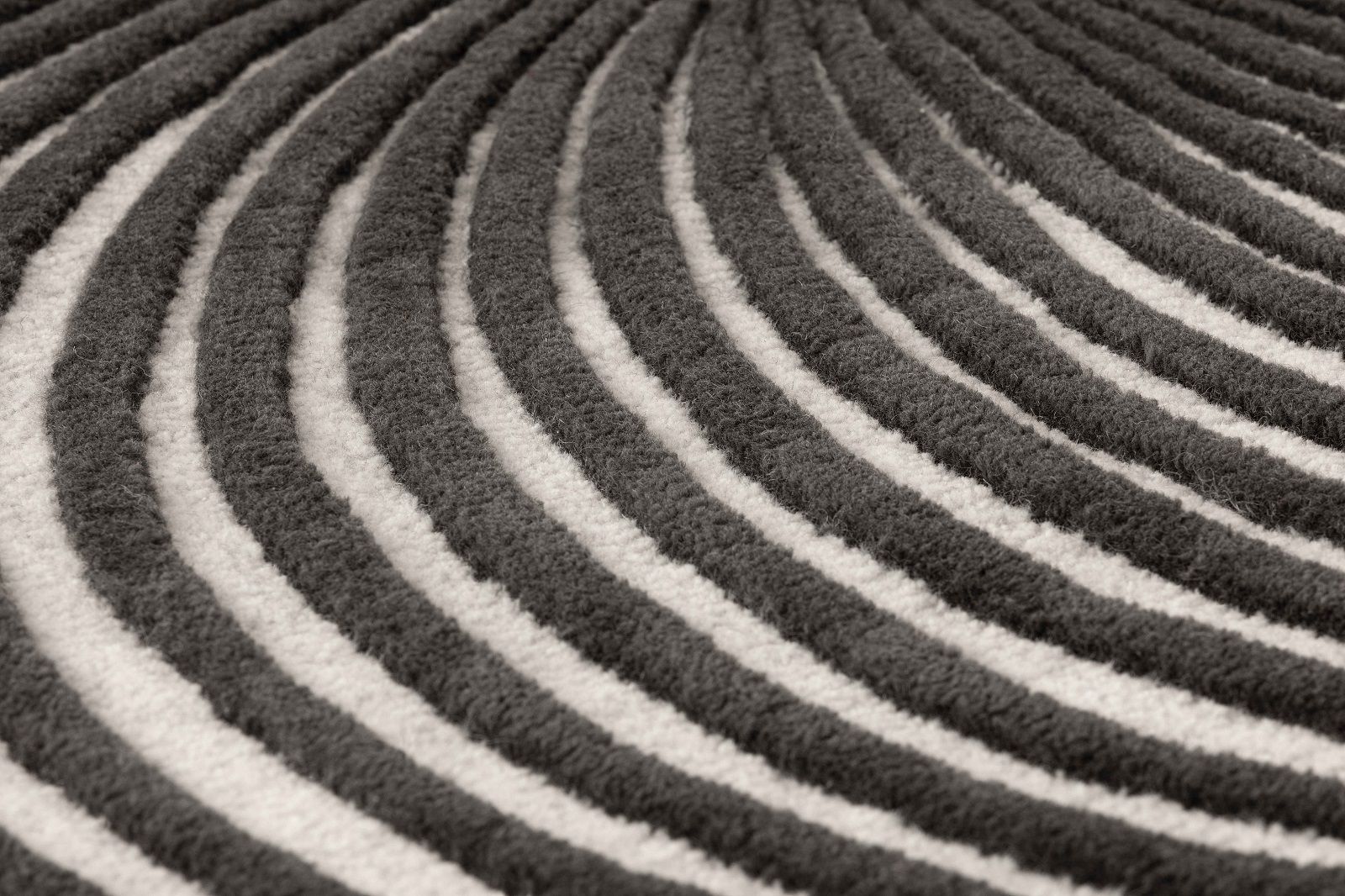 Detailaufnahme des Giro Rug Teppichs von Gan mit grau-weißen, wellenförmigen Streifen.