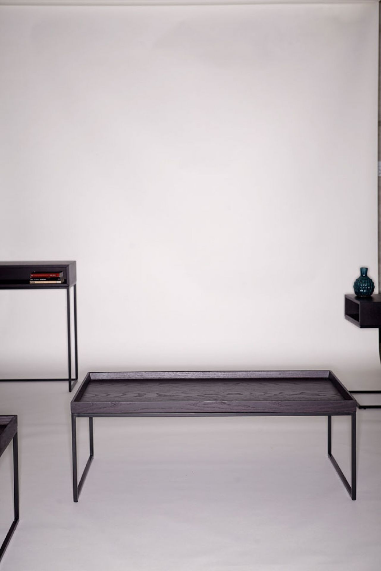 Pizzo Couchtisch von Jan Kurtz aus dunklem Eichenholz mit schwarzem Metallgestell. Moderner Wohnzimmertisch.