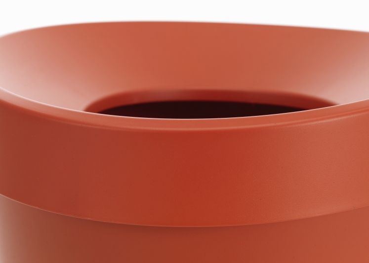 Detailaufnahme: Oberer Teil des orangefarbenen Vitra Happy Bin Papierkorbs.