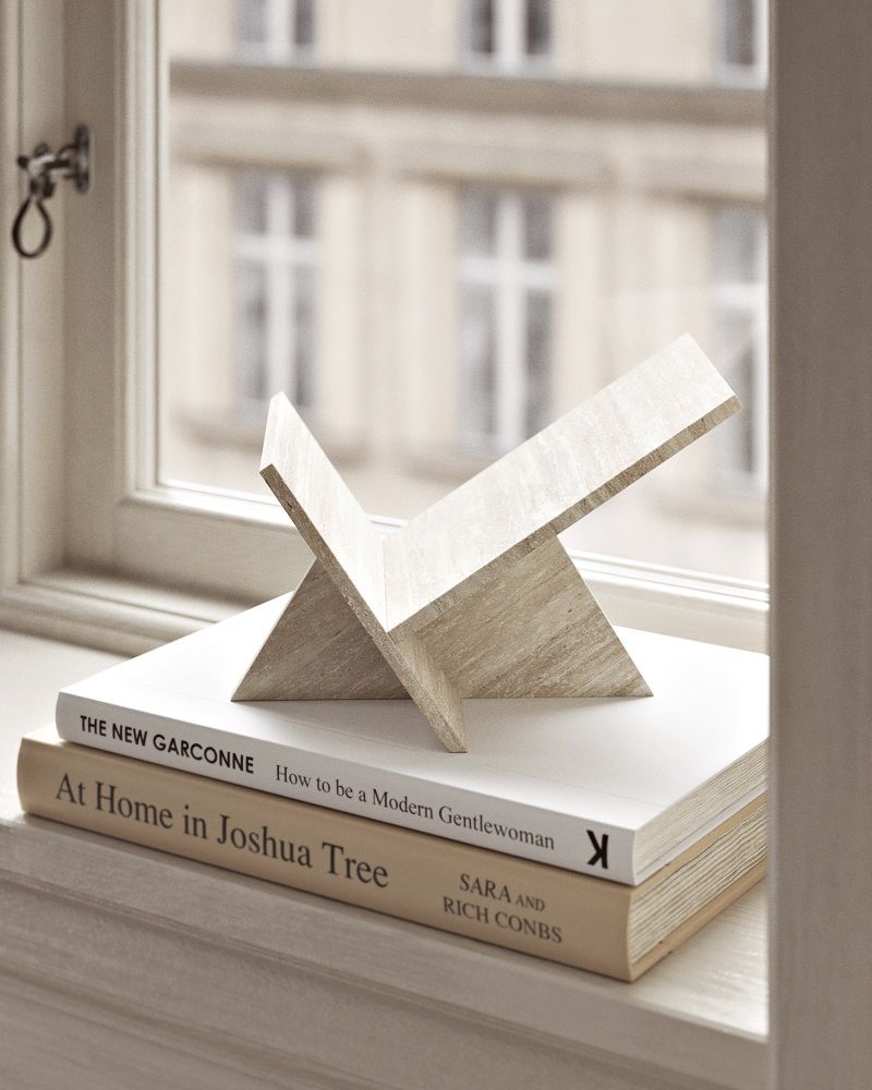 Mountain Magazine Holder Zeitschriftenhalter Woud aus hellem Holz auf zwei Büchern am Fenster.