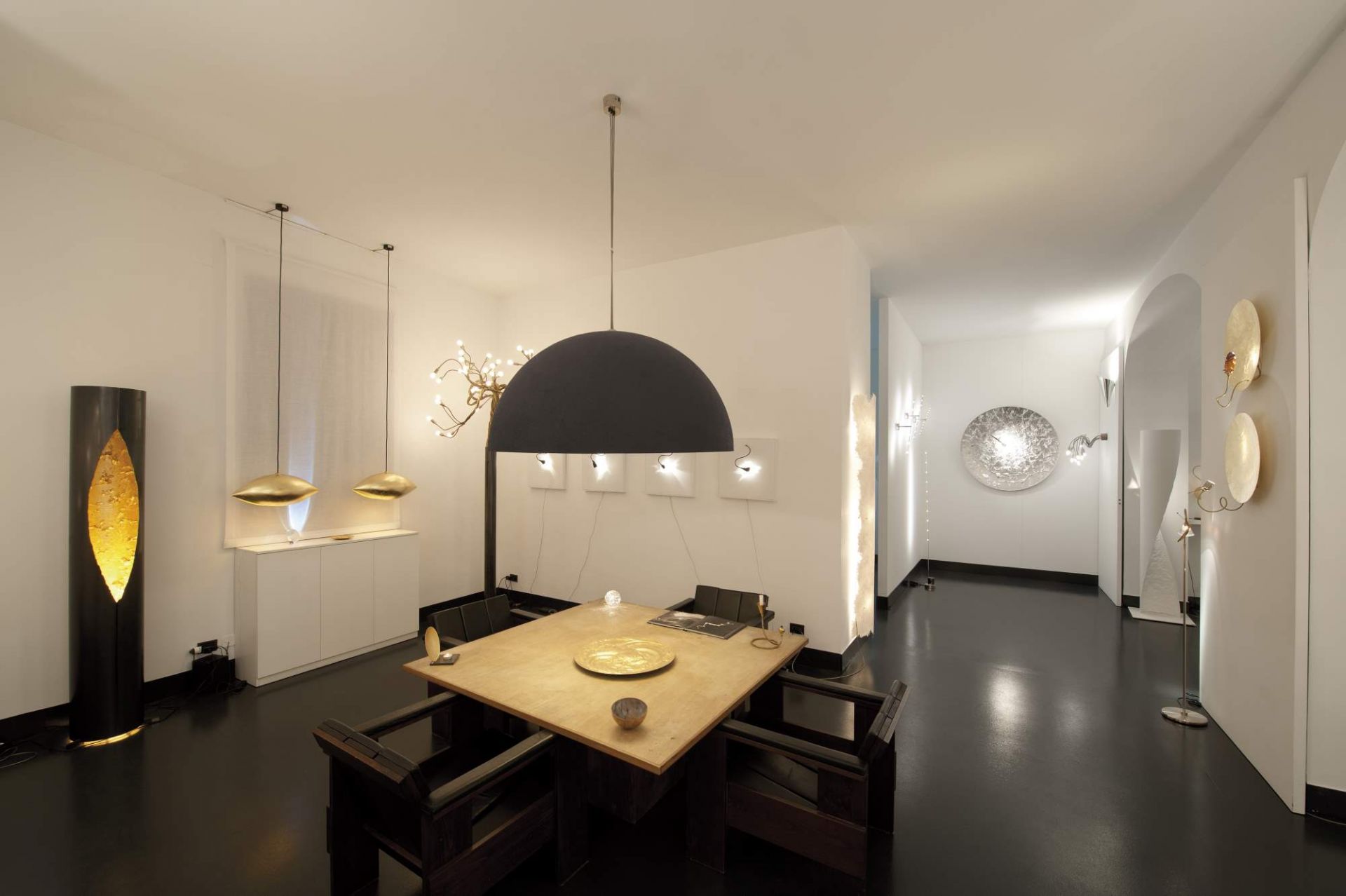 Esstisch mit großer, halbrunder, schwarzer Malagola Hängeleuchte von Catellani & Smith im modernen Interieur.