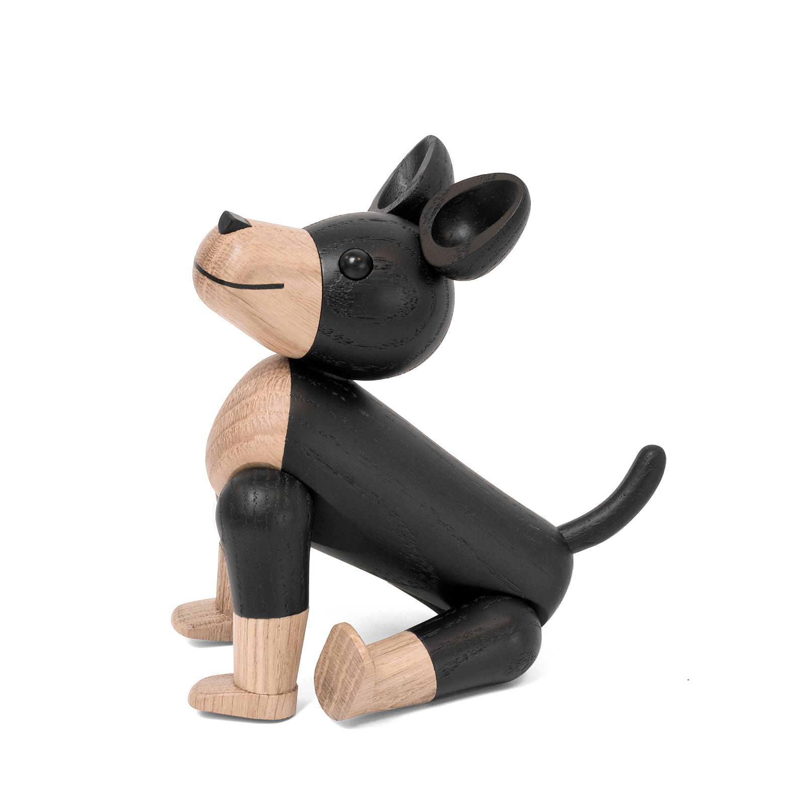 Novoform Charlie Hundefigur aus Holz, schwarz und natur, sitzend auf weißem Hintergrund. Dekorative Holzfigur.