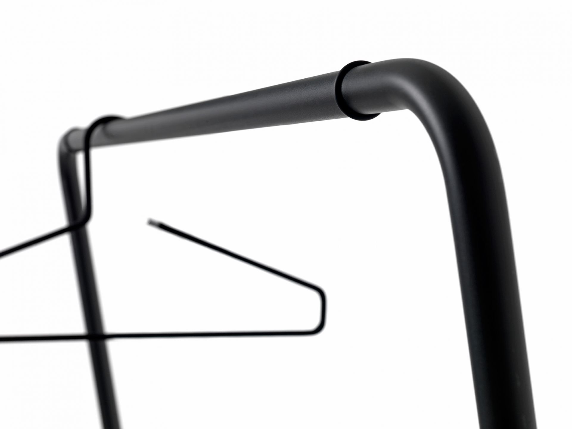 Detailaufnahme der schwarzen Curve Wandgarderobe von Schönbuch mit Kleiderbügel, minimalistisches Design für Flur und Garderobe.