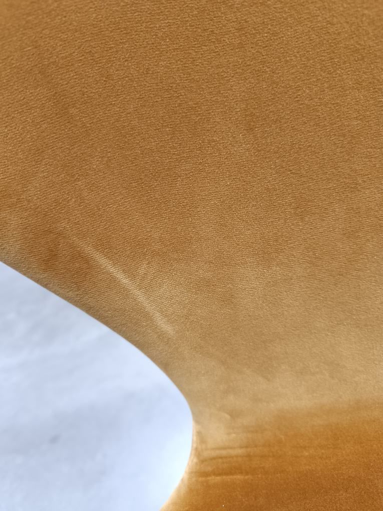 Detailaufnahme: Series 7 Stuhl mit Samtbezug in Ocker, vollgepolstert, modernes Möbeldesign.