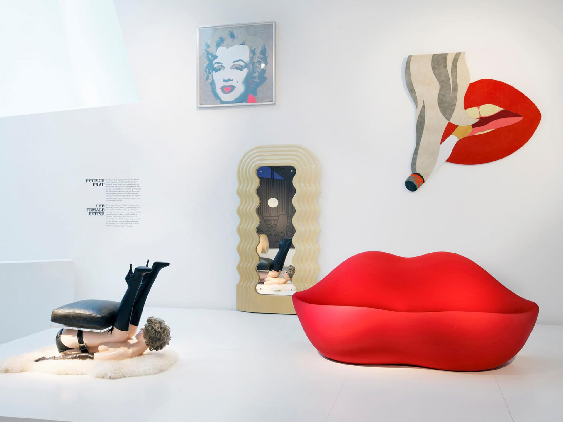 Rotes Bocca Sofa von Gufram in einem Ausstellungsraum mit Kunstobjekten. Design Möbel.