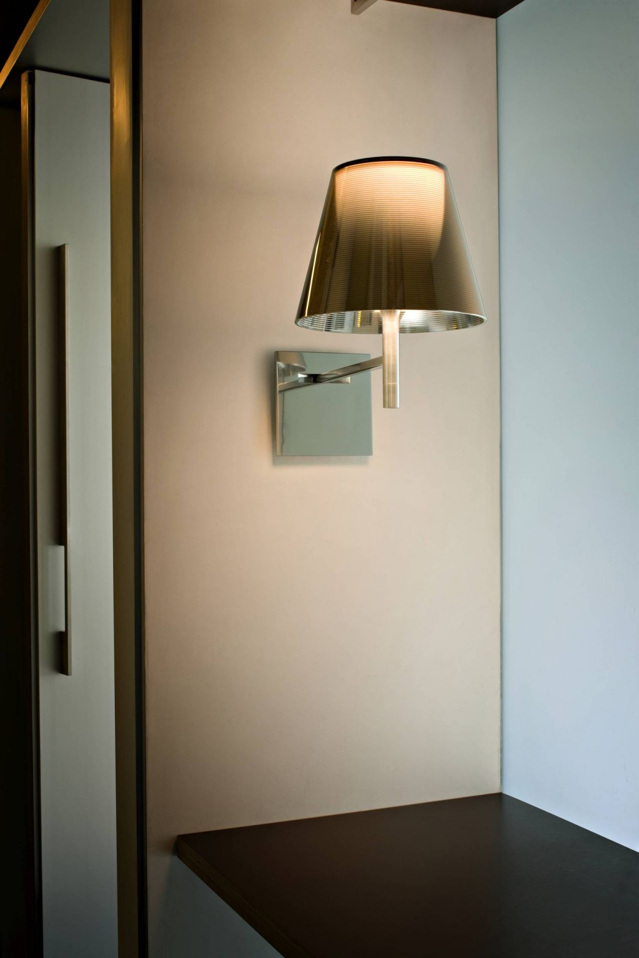 Ktribe Wandleuchte von Flos, modernes Design mit grauem Lampenschirm und warmem Licht.