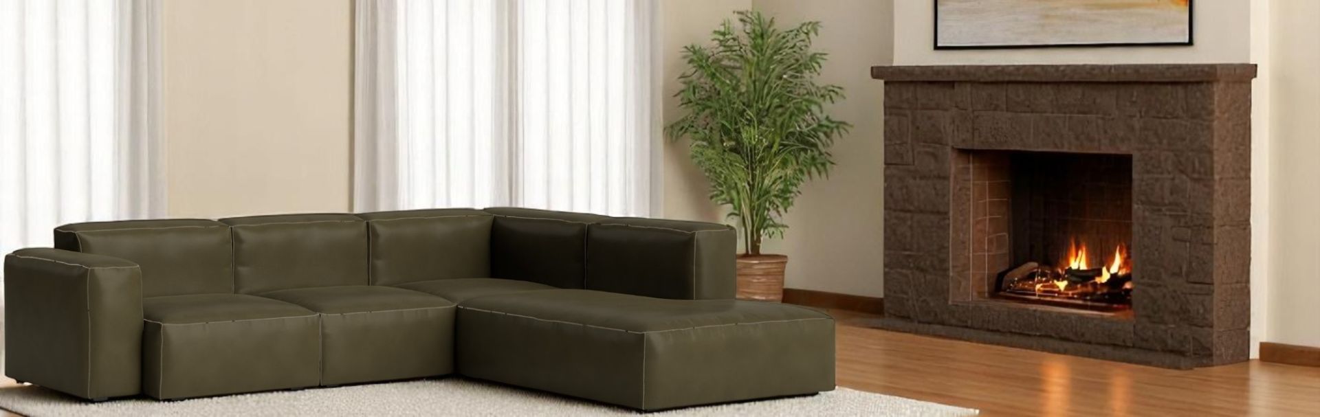 Grüne Mags Soft Sofa Eckkombination von Hay mit niedrigem Armteil und beigen Ziernähten.