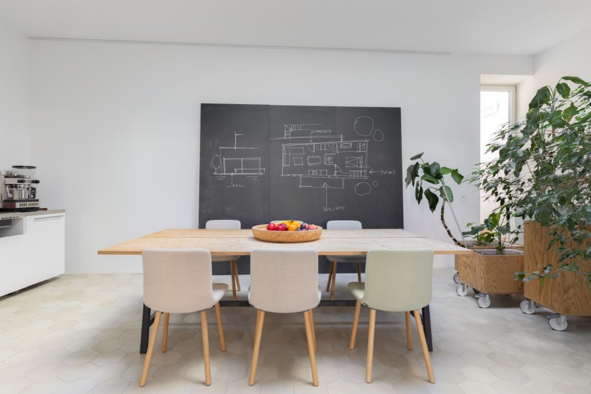 Esszimmer mit Holztisch und mehreren Hal Soft Wood Stühlen von Vitra.