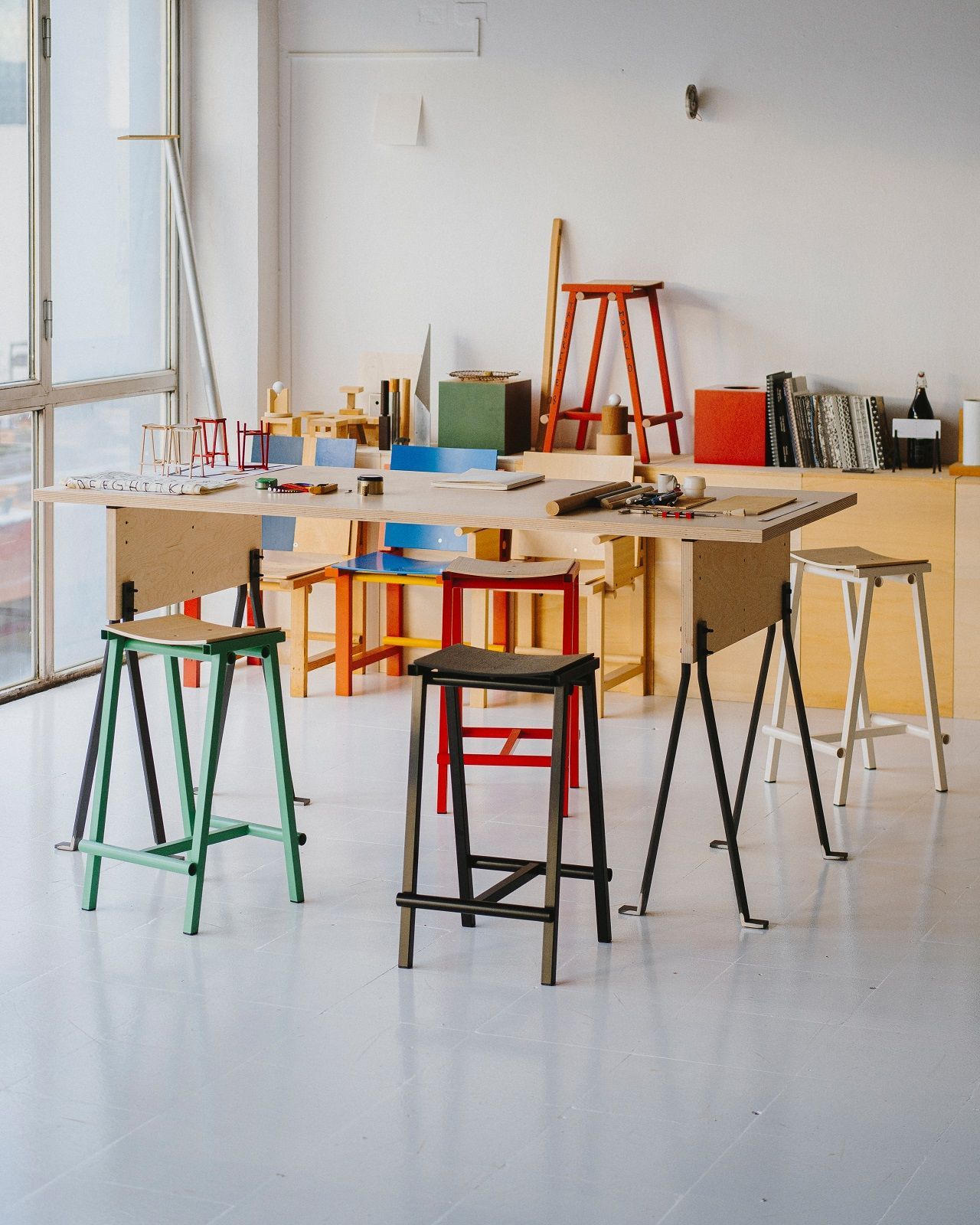 Mehrere Hay Barhocker Taburete 8 in verschiedenen Farben in einem hellen Raum.