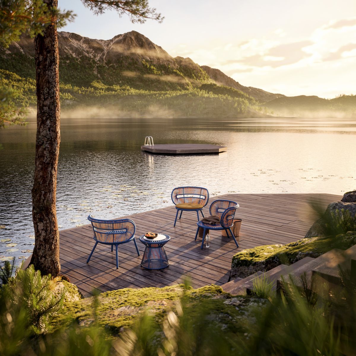 Cirql Nu Beistelltisch von Dedon mit Outdoor-Möbeln auf Holzterrasse am See. Gartenmöbel für entspannte Stunden.