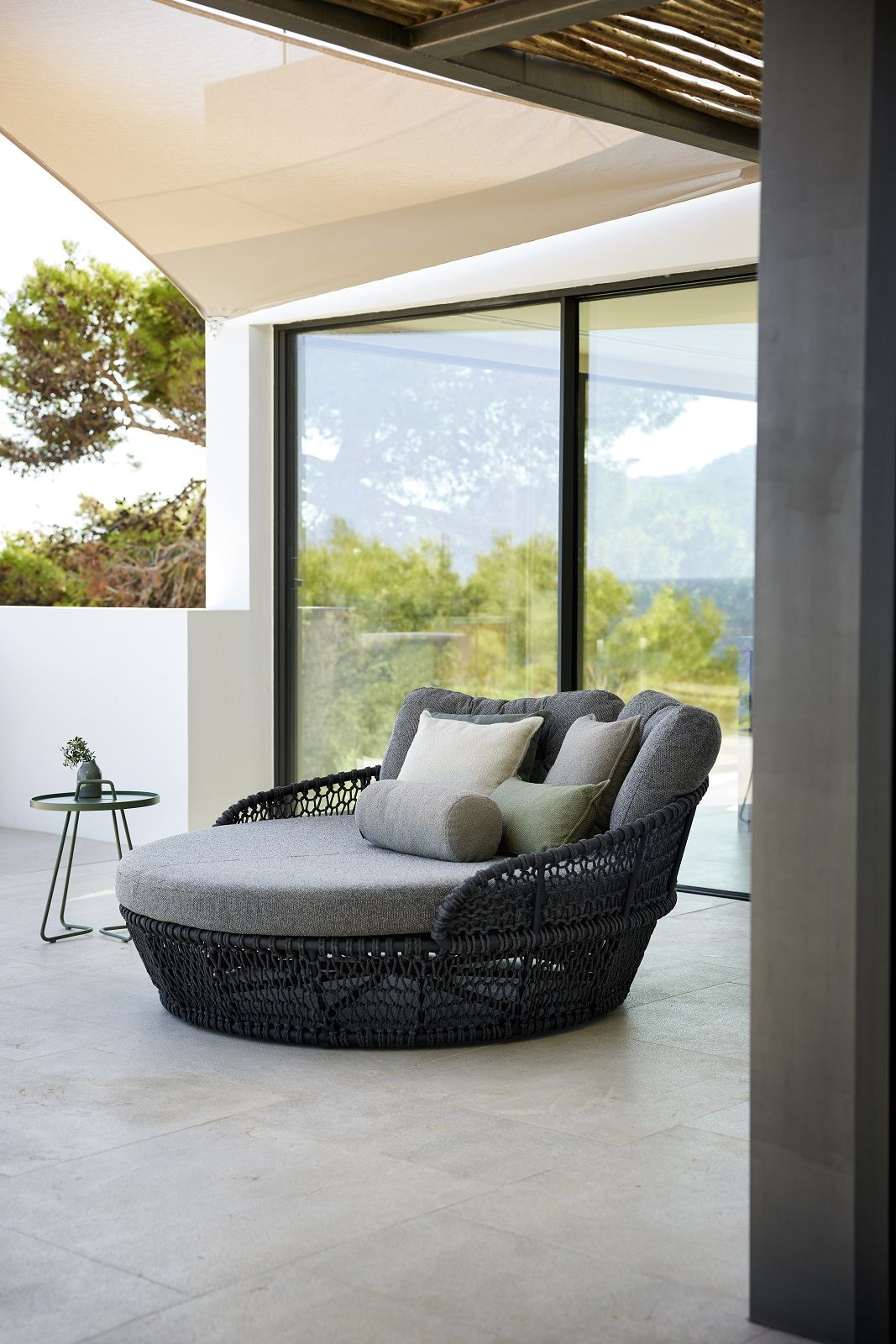 Dunkelgraues Cane-Line Ocean Daybed mit weicher Seilflechtung und Kissen für den Außenbereich.