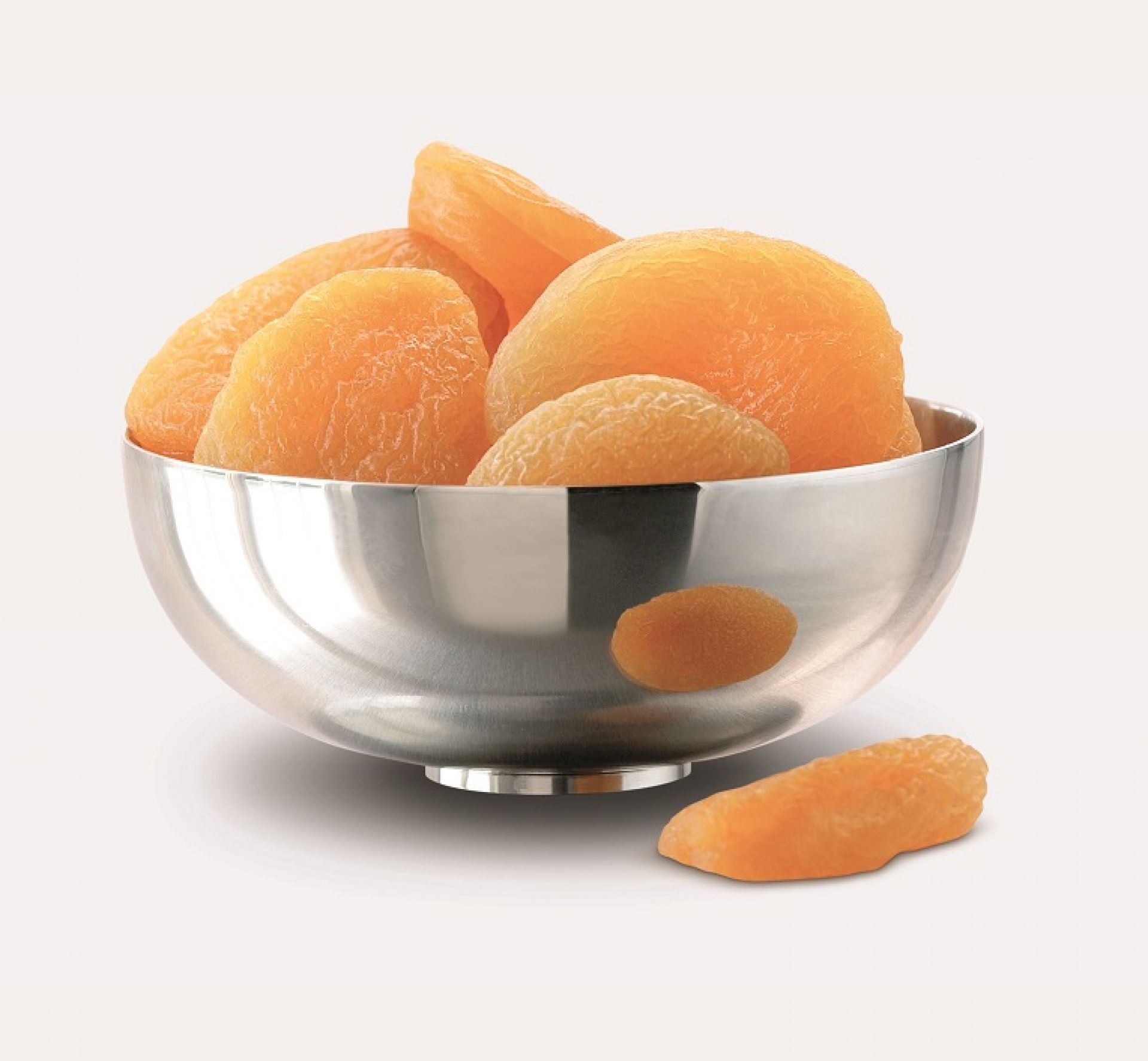 Piet Hein Bowl Schale aus Edelstahl gefüllt mit getrockneten Aprikosen. Dekorative Obstschale.