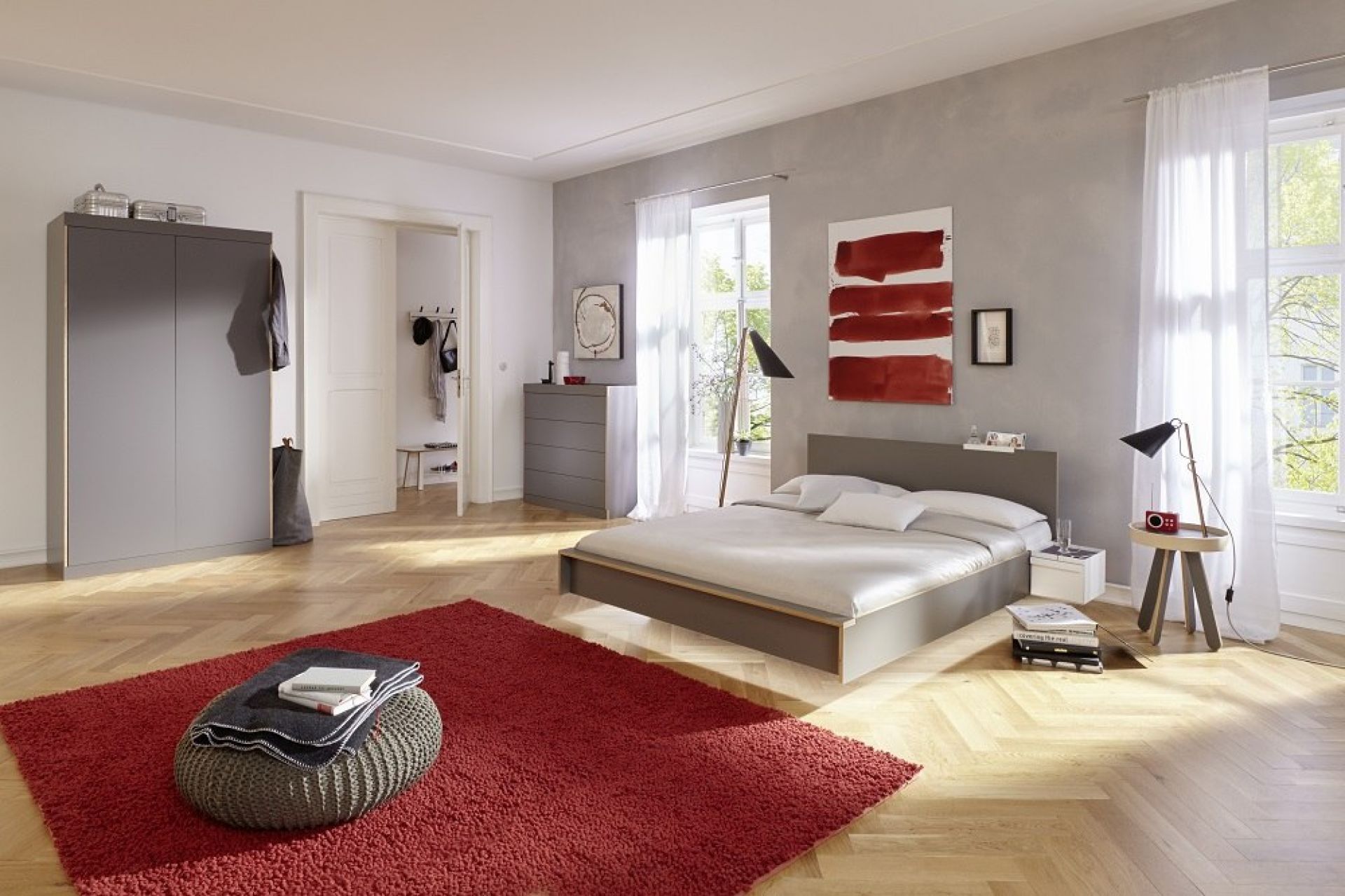 Schlafzimmer mit grauer Flai Kommode von Müller Möbelwerkstätten und passendem Bett.