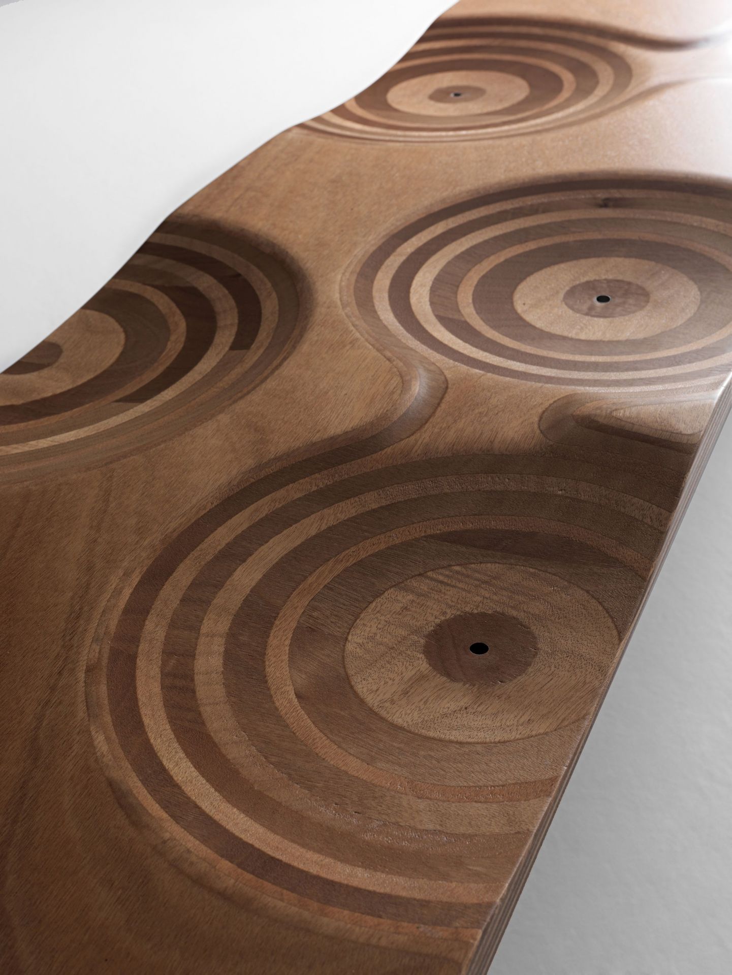 Detailaufnahme der Ripples Bank von Casamania Horm mit konzentrischen Kreisen im Holz.