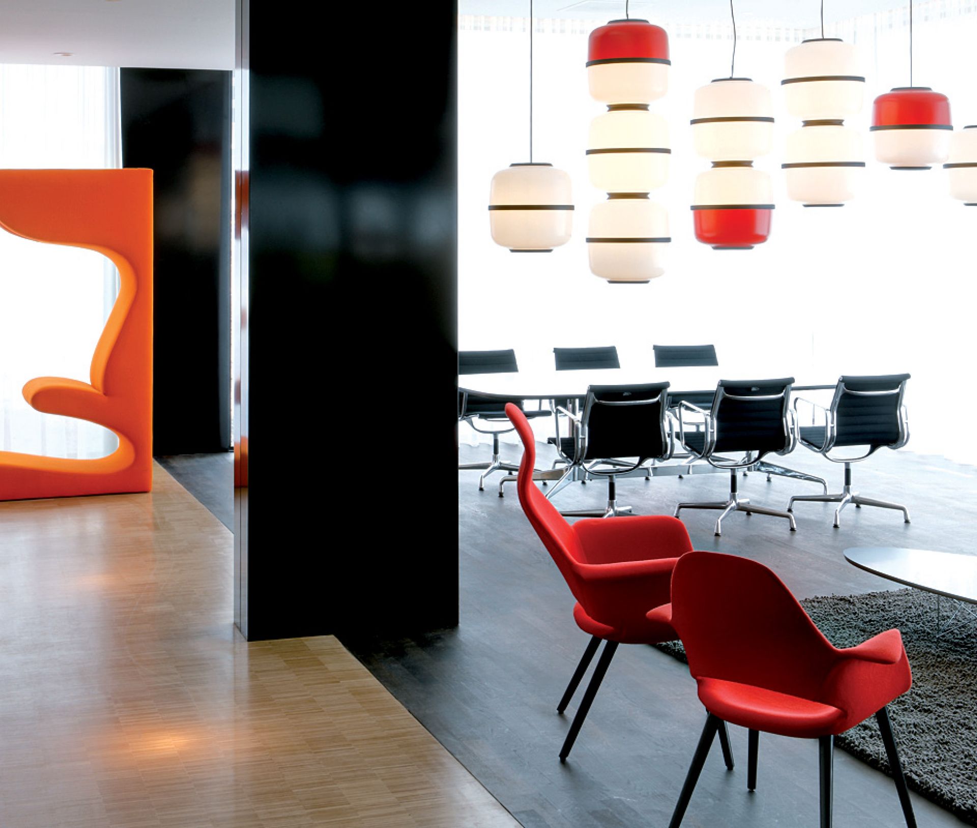 Orange Living Tower Sitzskulptur von Vitra in modernem Büroambiente mit Konferenztisch und Stühlen.