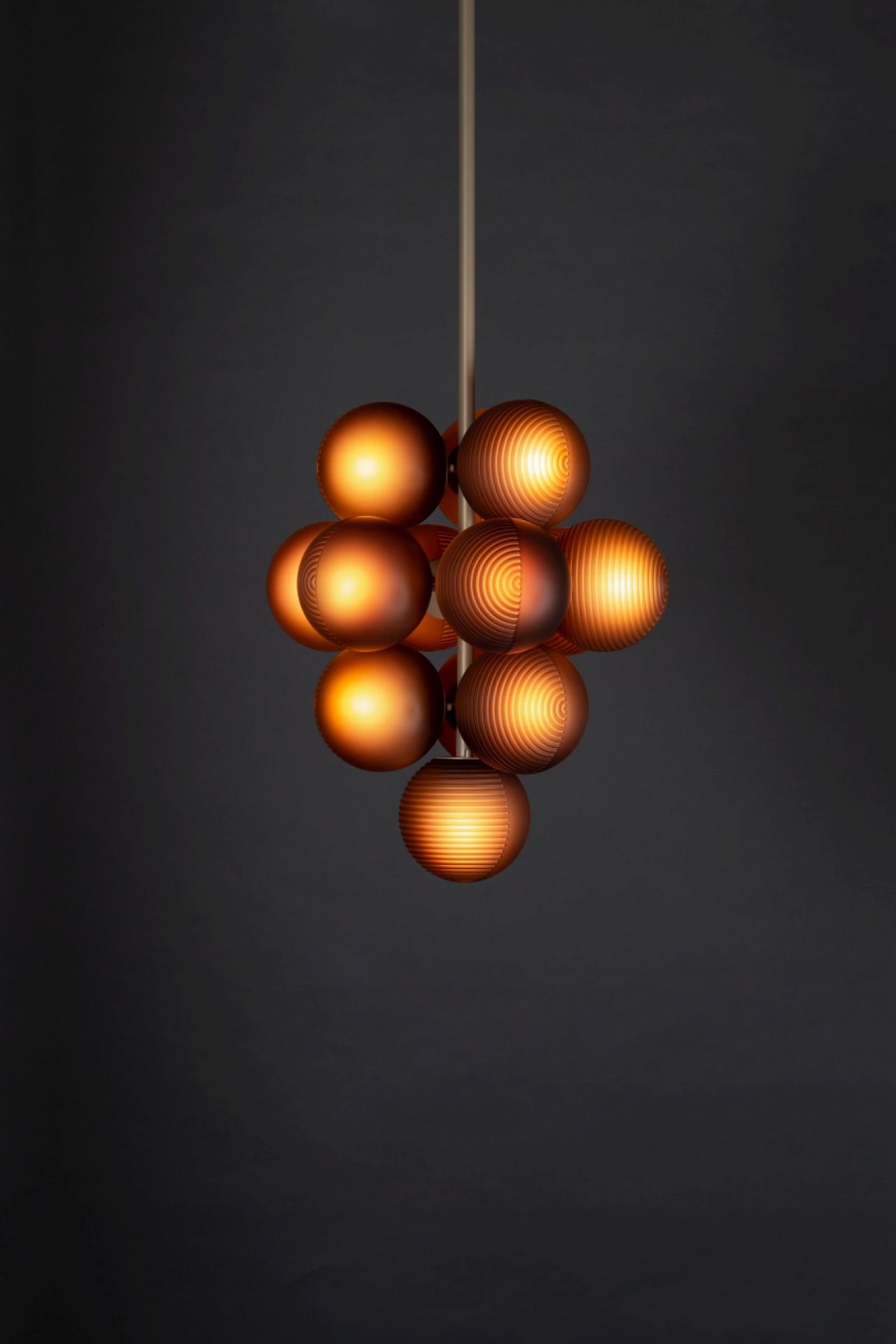 Nahaufnahme der Stellar Grape Pendelleuchte von Pulpo mit warmem, diffusem Licht.