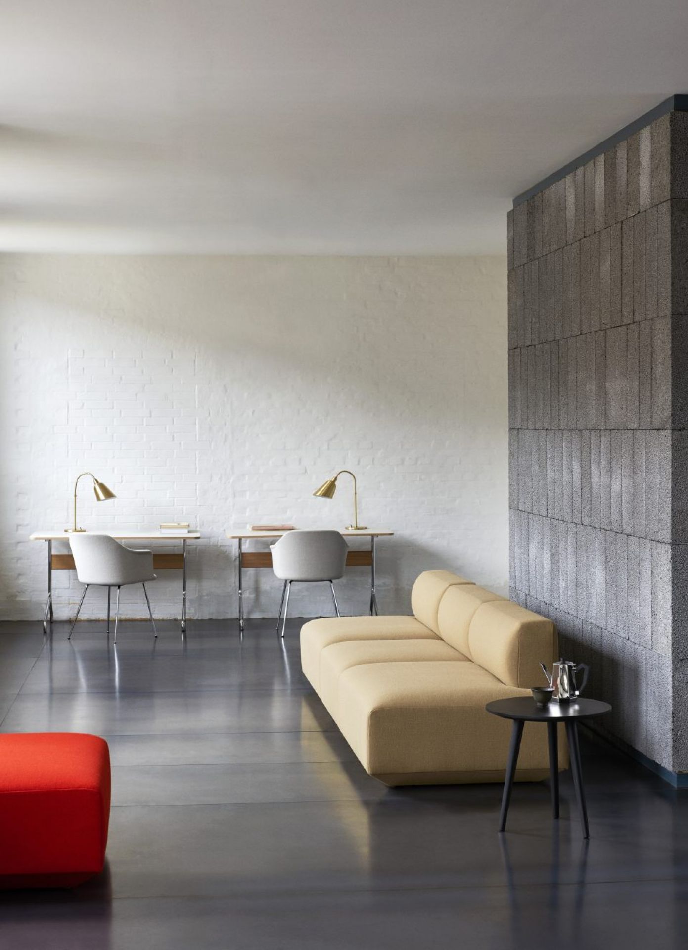 AndTradition Pavilion Schreibtisch AV16/AV17 in hellem Raum mit Sofa und minimalistischem Design. Moderner Sekretär für Büro und Homeoffice.