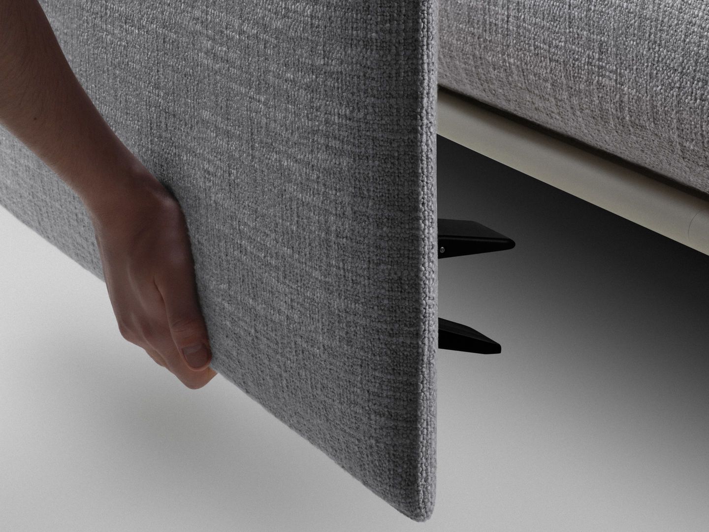 Graues Vitra Anagram Panel wird von einer Hand gehalten, Detailaufnahme der Stoffstruktur und Befestigung.