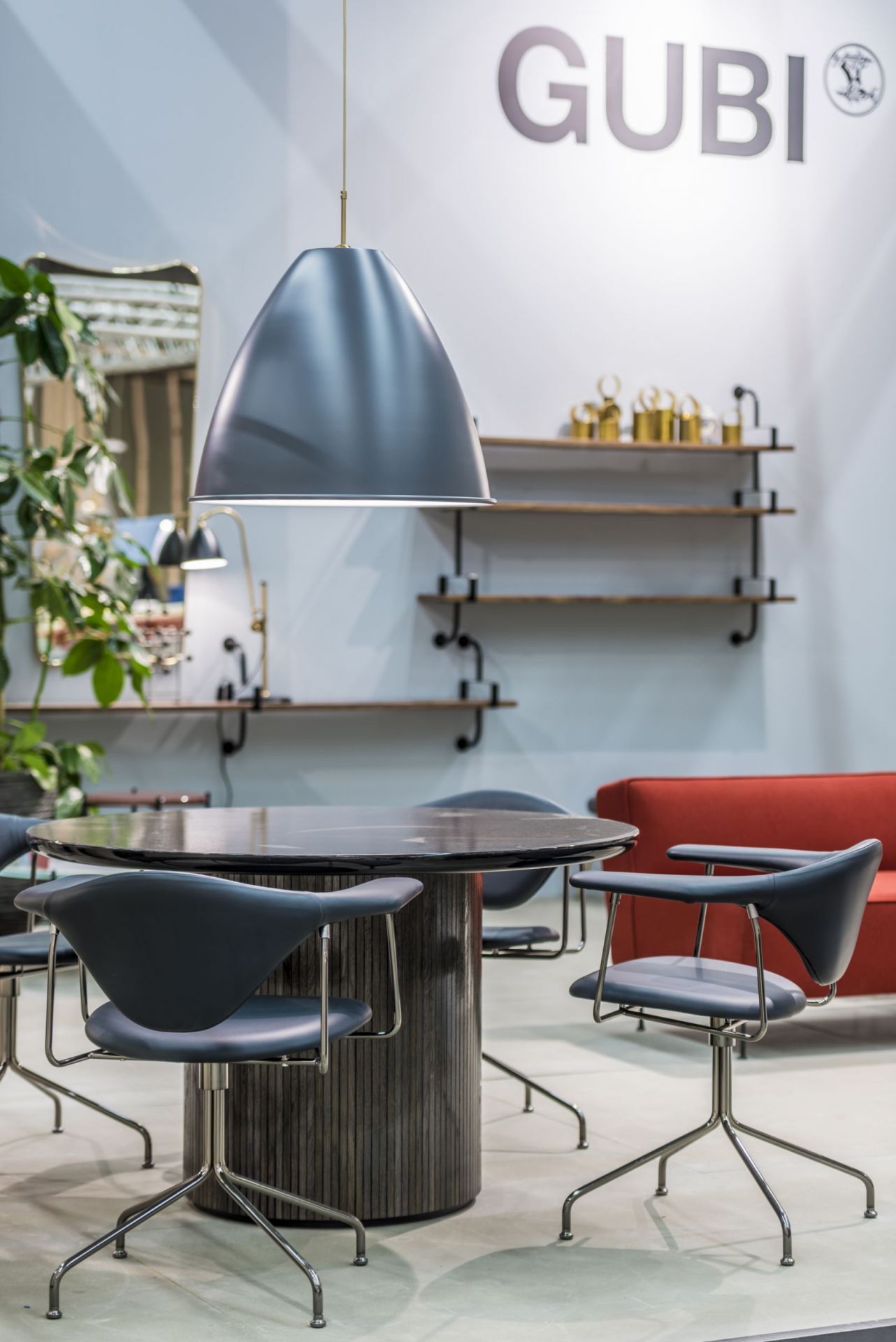 Runder Moon Esstisch von Gubi mit Stühlen und Pendelleuchte in einem modernen Ambiente.