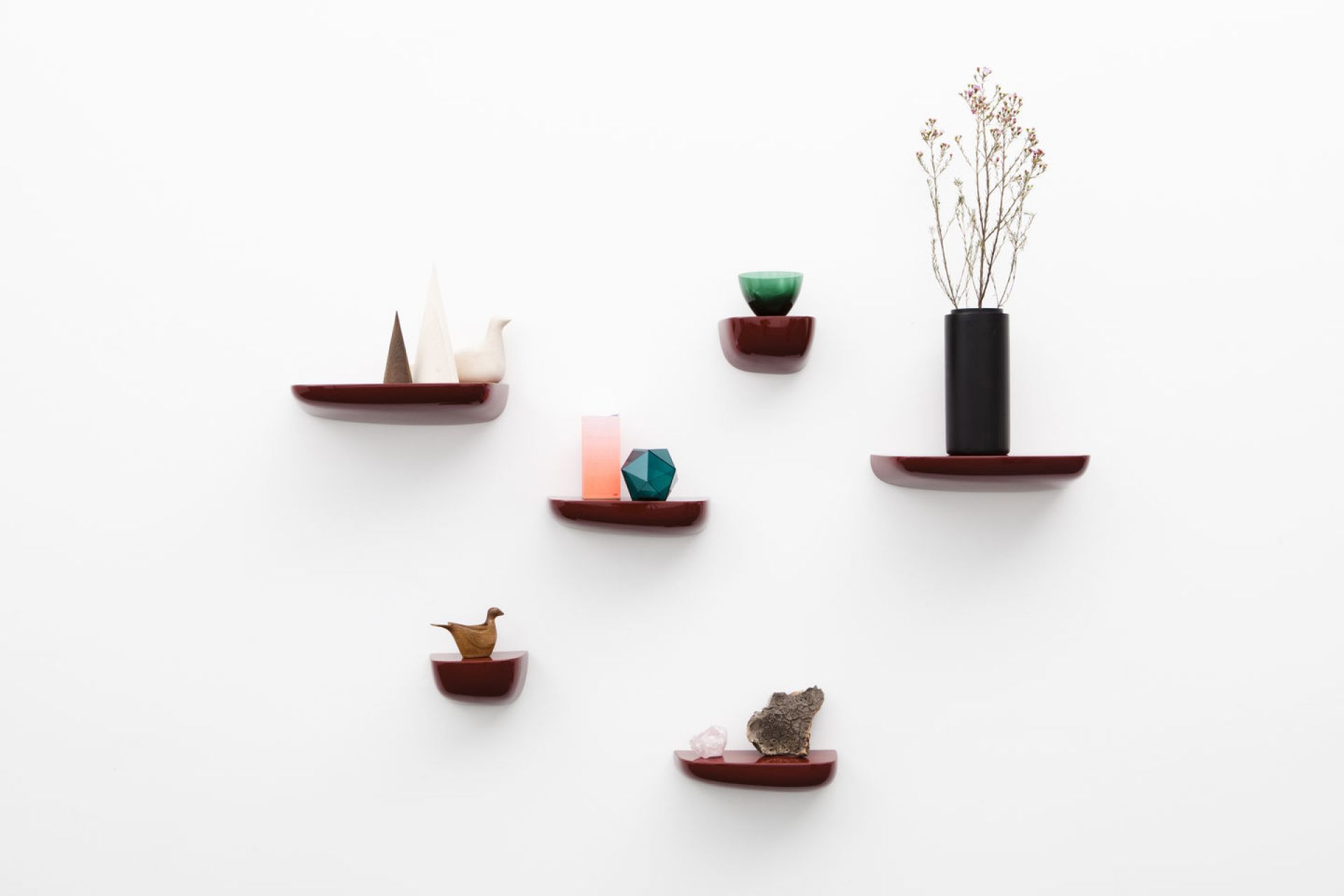 Mehrere Corniches Wandboards von Vitra in Rotbraun an einer weißen Wand mit Deko.