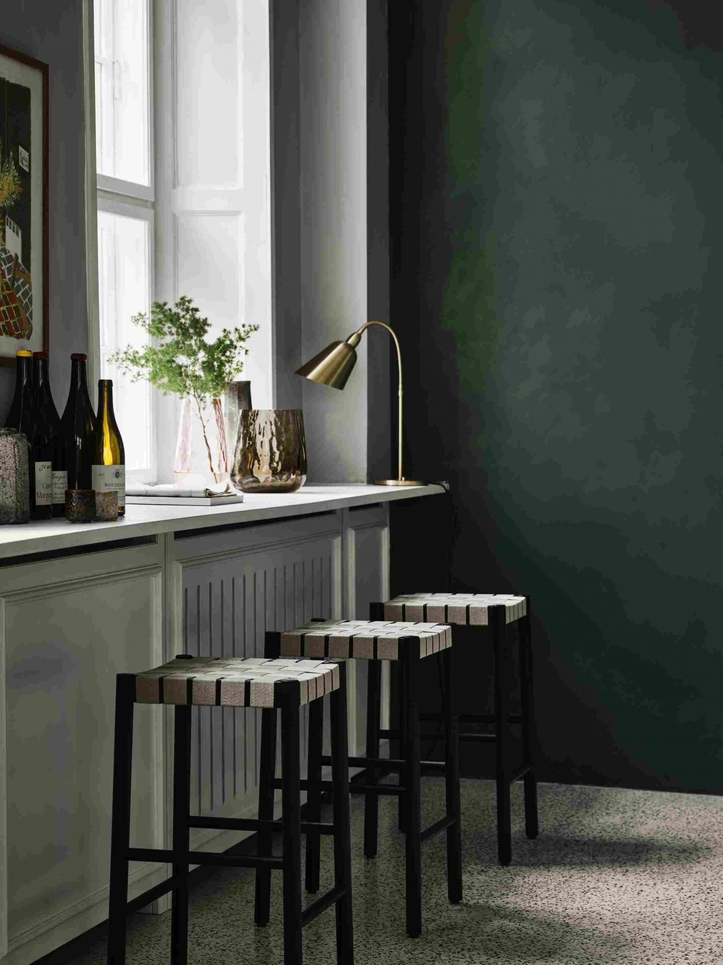 Drei Betty TK7 Barhocker von Andtradition mit schwarzem Gestell und geflochtenem Sitz vor Küchentheke.