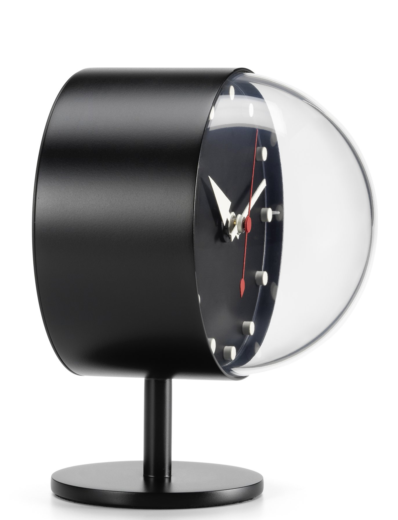 Schwarze Vitra Night Clock Tischuhr mit transparentem Zifferblatt und rotem Sekundenzeiger auf weißem Hintergrund.