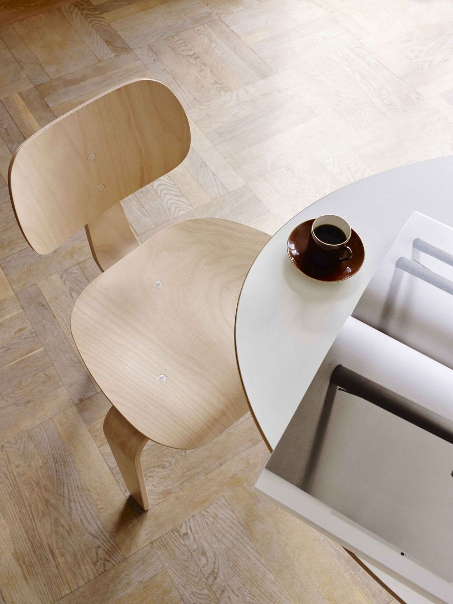 Draufsicht: Heller SE 42 Stuhl von Wilde+Spieth neben Tisch mit Kaffeetasse. Designmöbel.