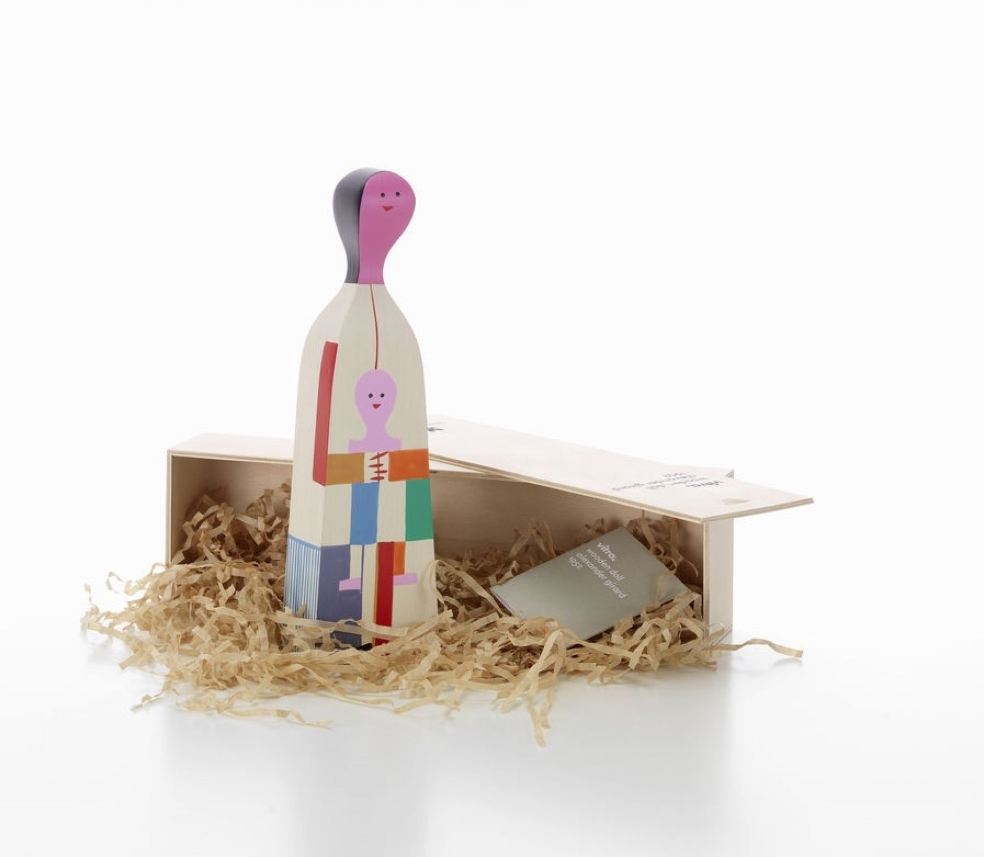Vitra Wooden Doll No. 4, dekorative Holzfigur mit abstrakten Mustern in einer Holzkiste.