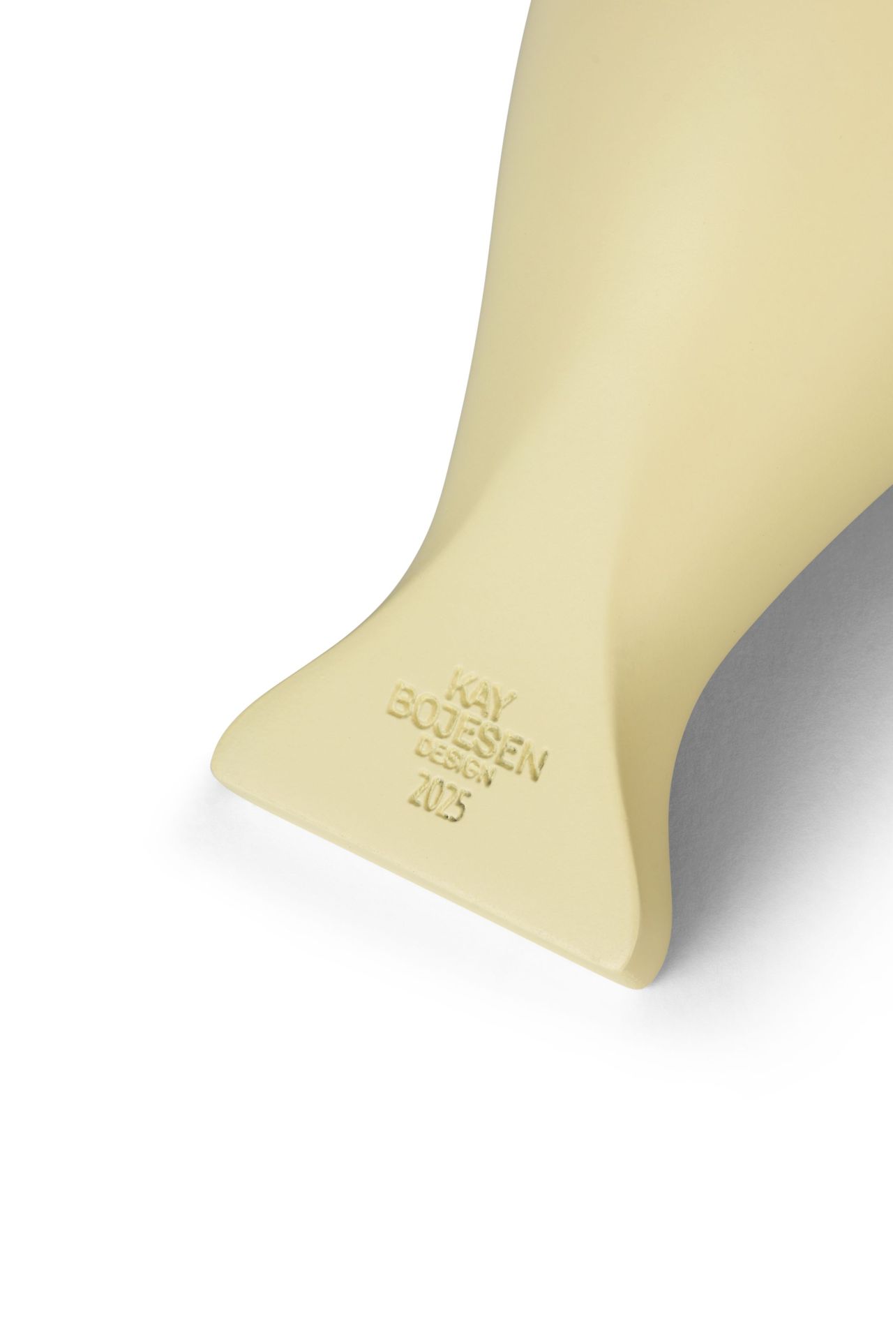 Detailaufnahme der Kay Bojesen Year Bird Bella 2025, beige Holzfigur mit eingraviertem Schriftzug und Jahreszahl.