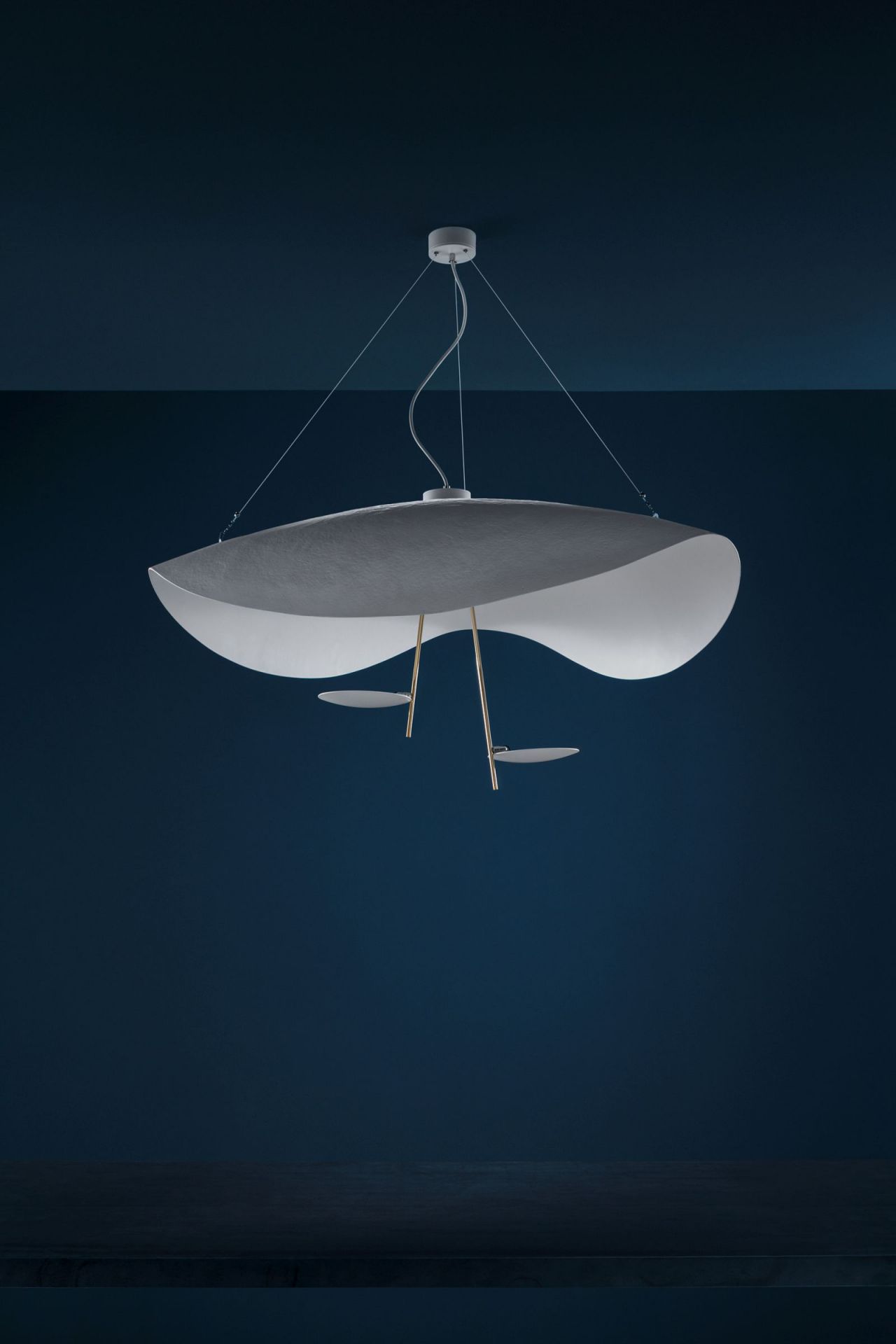 Moderne Lederam Pendelleuchte von Catellani & Smith in Grau und Weiß vor blauem Hintergrund.