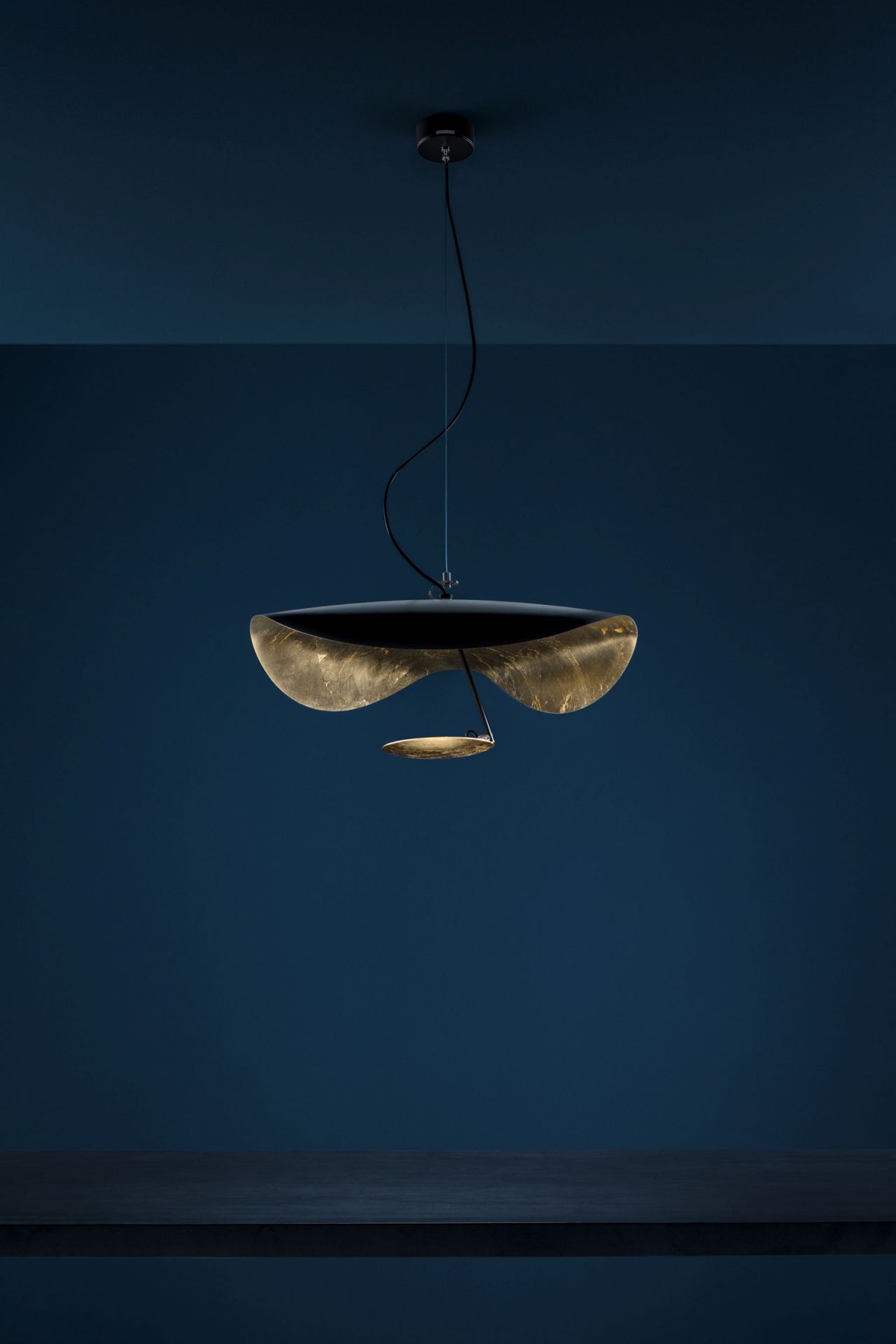 Lederam Pendelleuchte von Catellani & Smith: Moderne Hängelampe mit goldenen Reflektoren und warmem Licht.