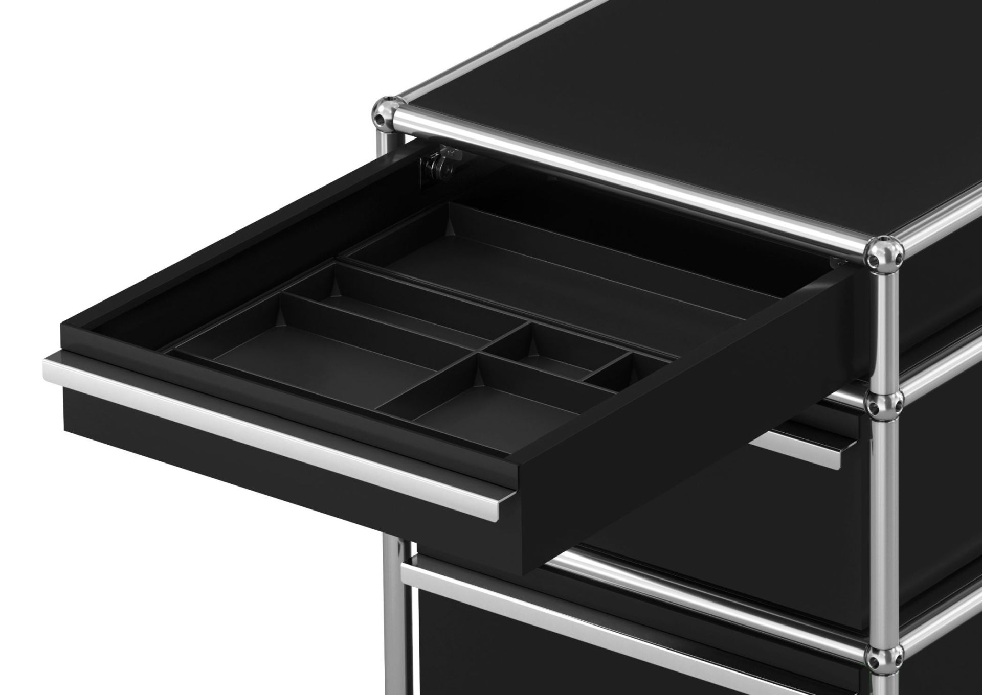 Detailaufnahme: Schwarzer USM Haller Rollcontainer mit drei Schubladen, eine Schublade ist geöffnet und zeigt Facheinteilung.