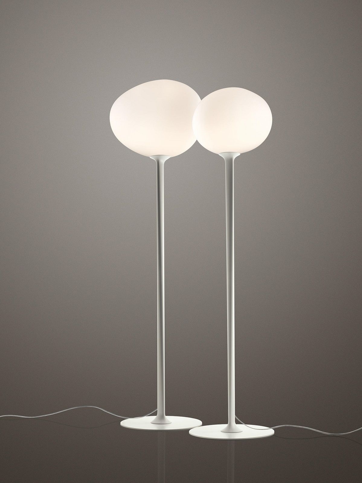Zwei moderne Gregg Stehleuchten von Foscarini mit runden, diffusen Lampenschirmen.