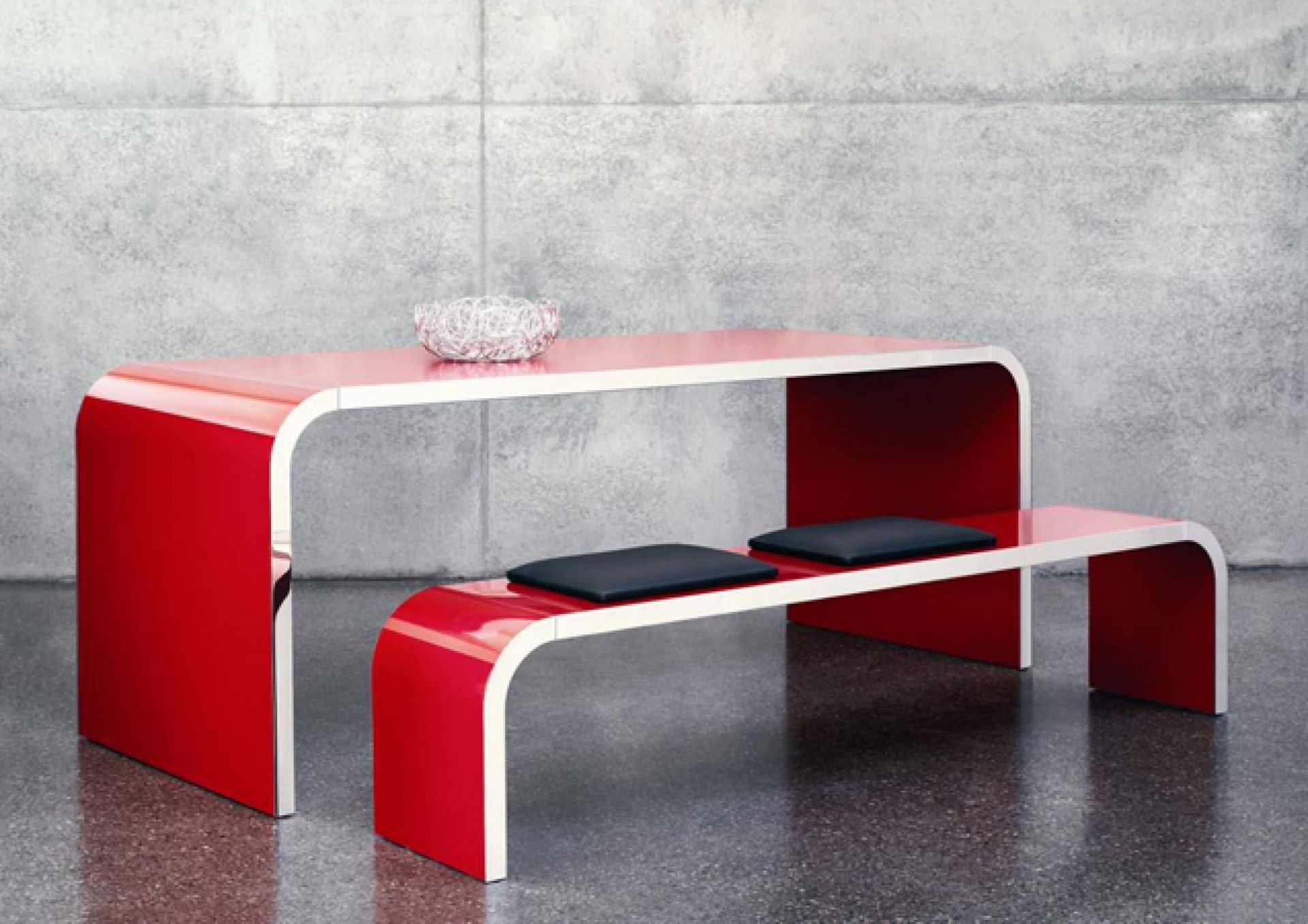 Roter M10 Highline Tisch von Müller Möbelfabrikation mit passender Bank und schwarzen Kissen.