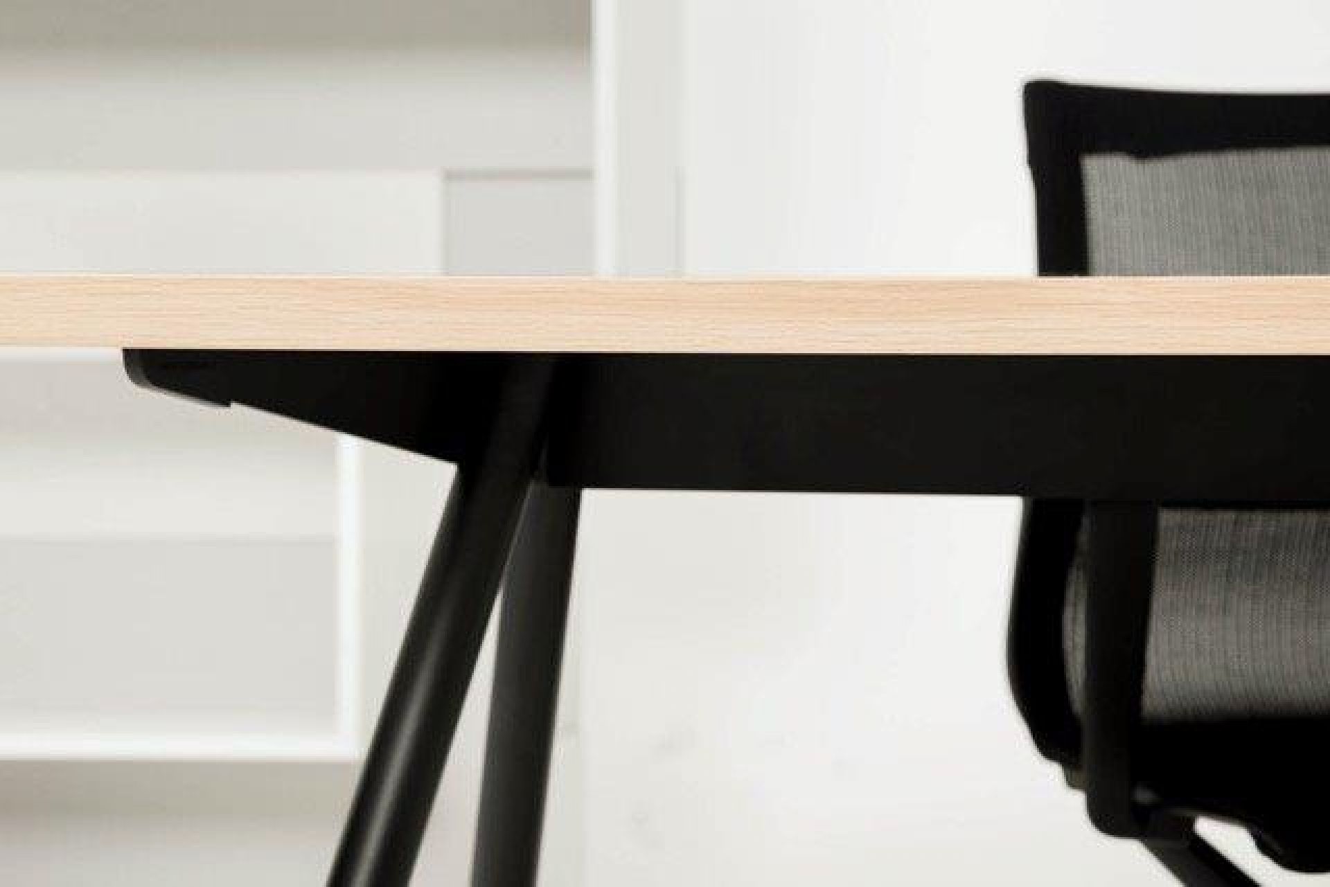 Detailaufnahme: New Tendency Masa Tischgestell aus Stahl mit heller Tischplatte und schwarzem Untergestell.